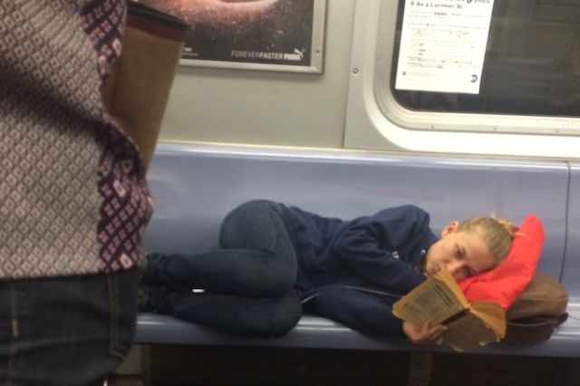 This is how you need to sit on the subway if you don't want anyone reading over your shoulder.